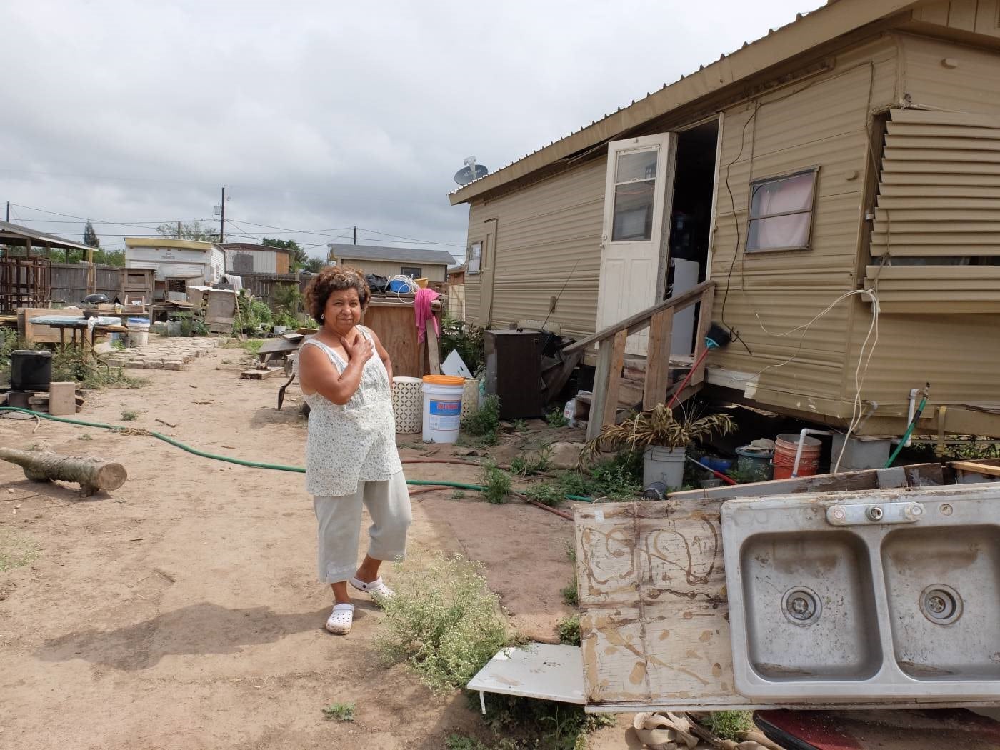 A woman standing in front of a trailer