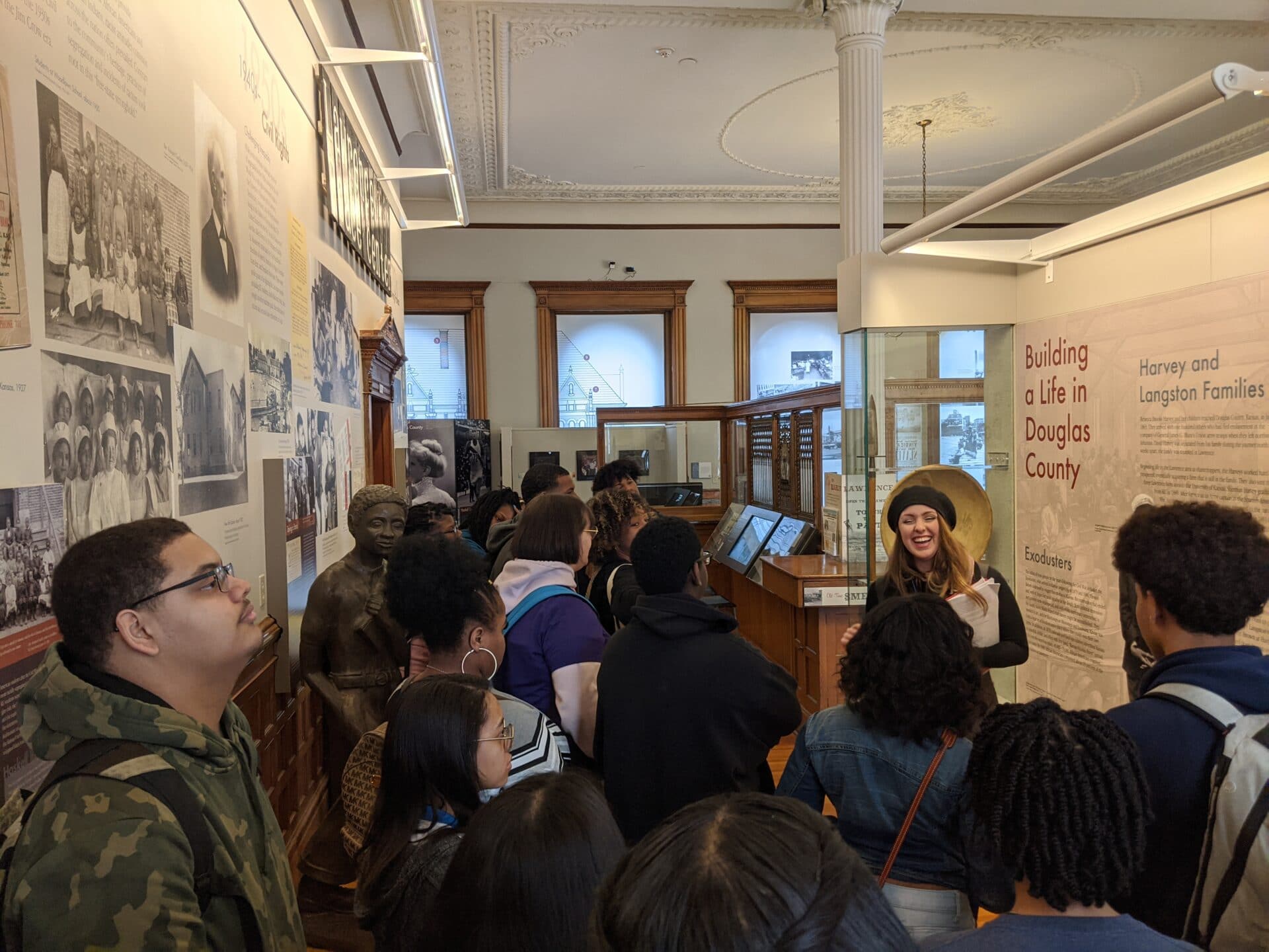 group of people looking at the art on wall