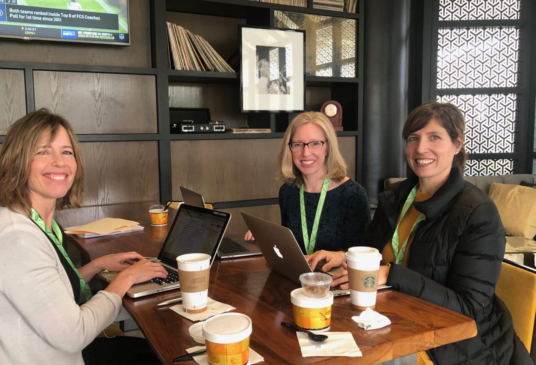 people in meeting with coffee over table.