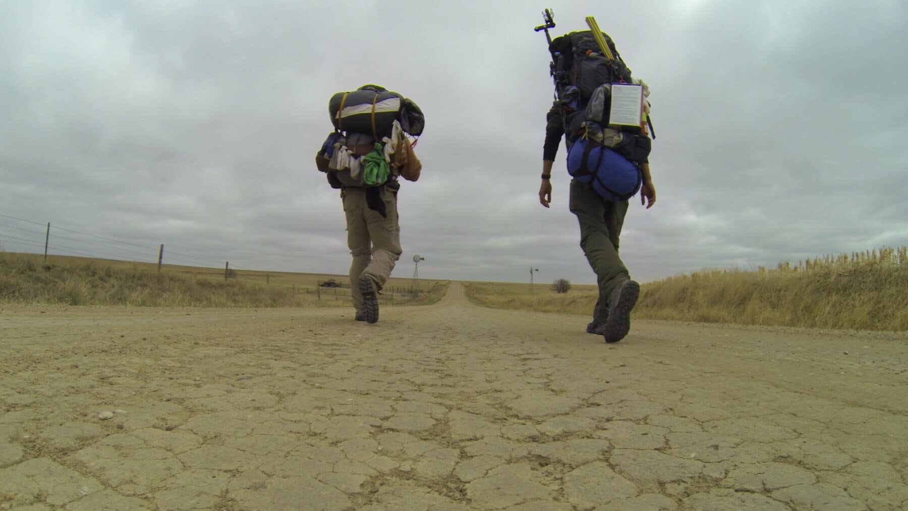 Backpackers walking on a dirt road