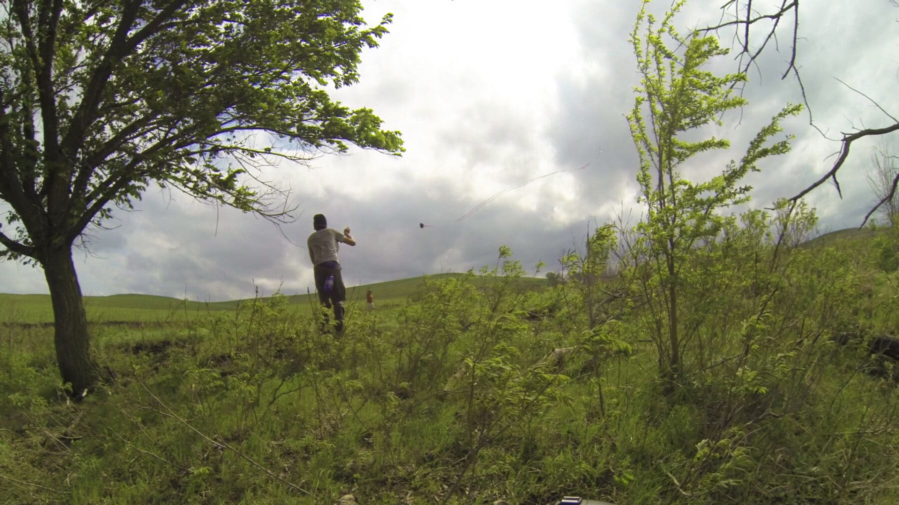 Two people flying a kite in a field