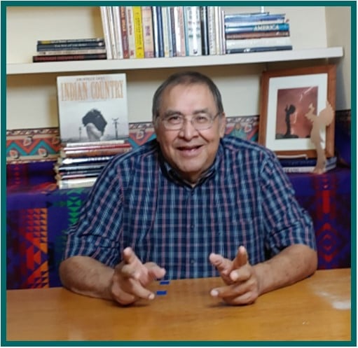 person surrounded with books behind.