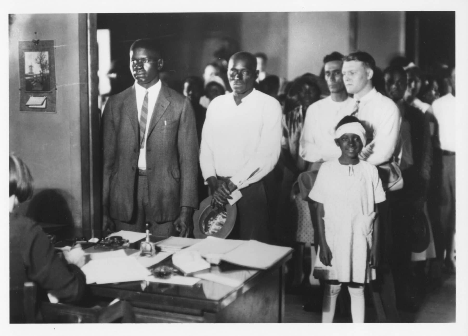 A black and white photo of patients in the waiting room