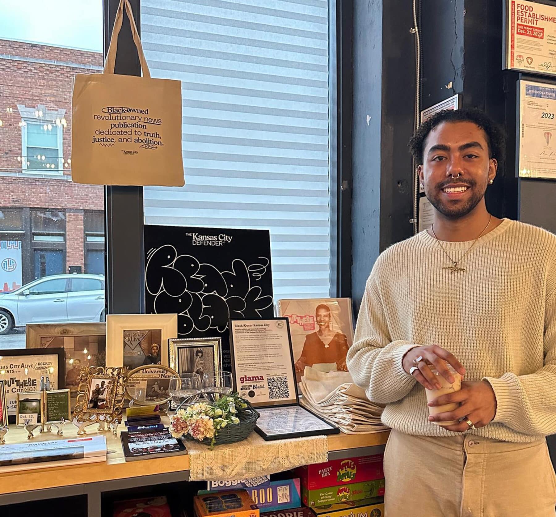 Nasir Anthony Montalvo in front of a display of images from the project