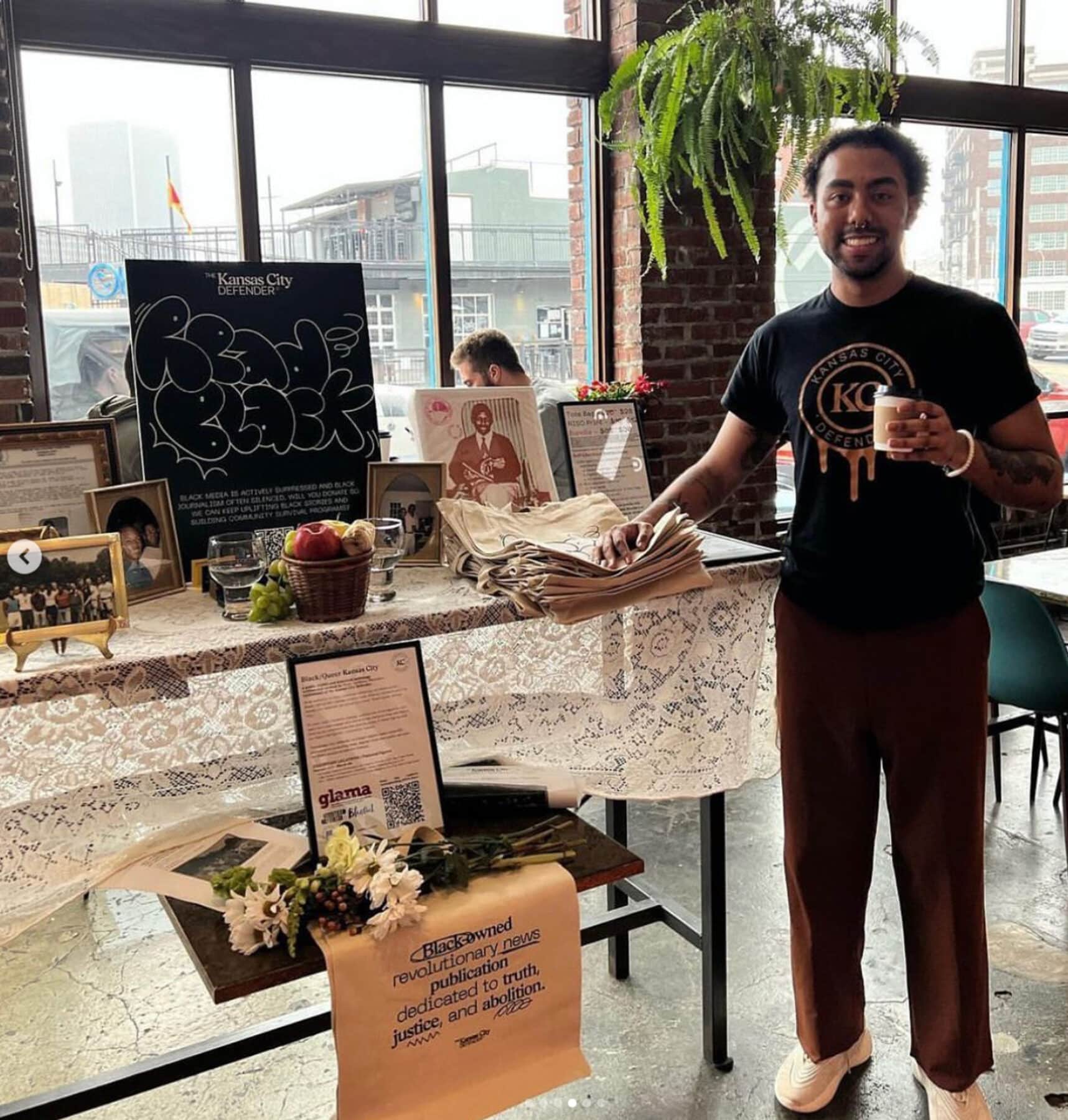 Nasir Anthony Montalvo in front of a display of images from the project