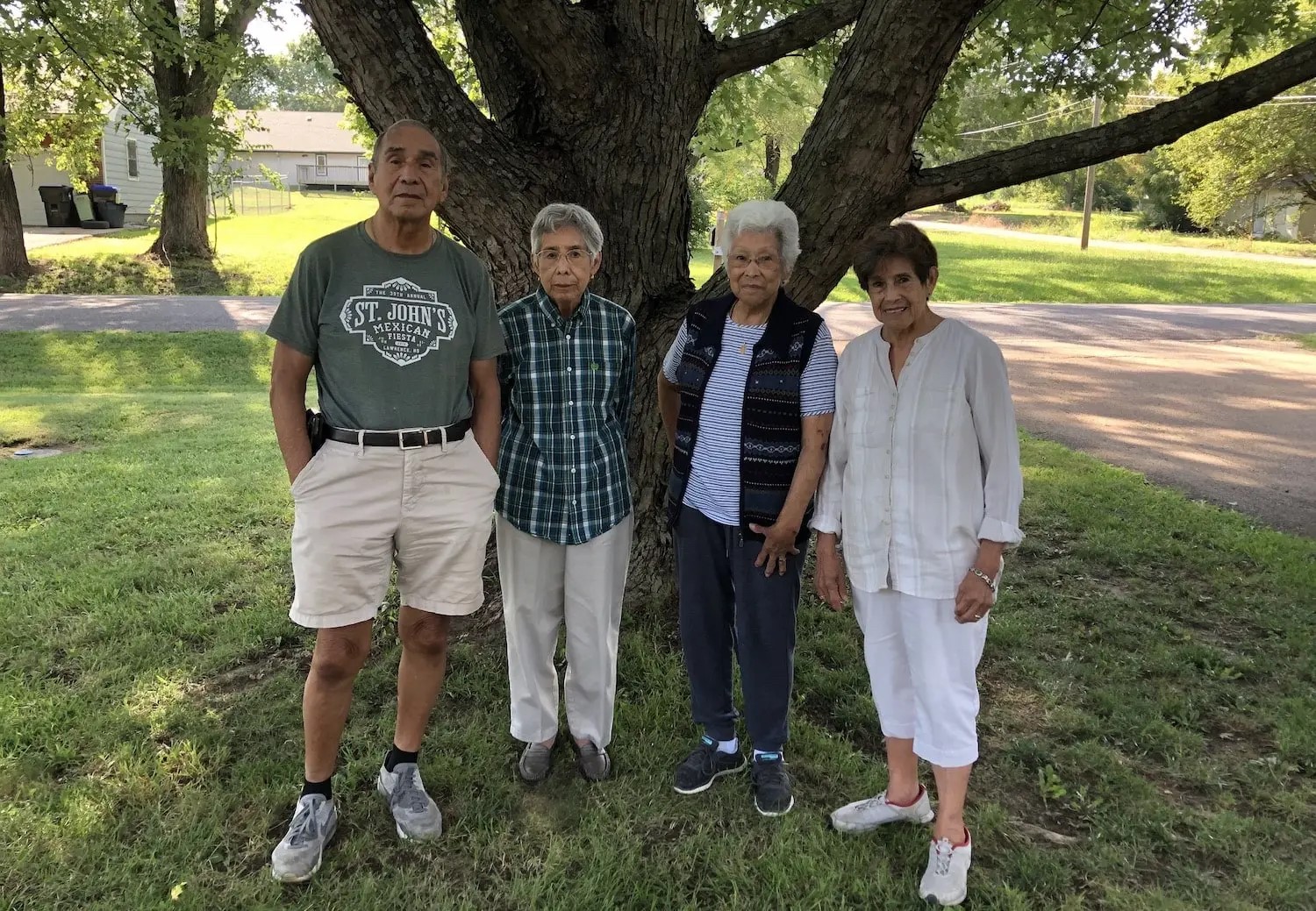 A group of people standing beneath a tree