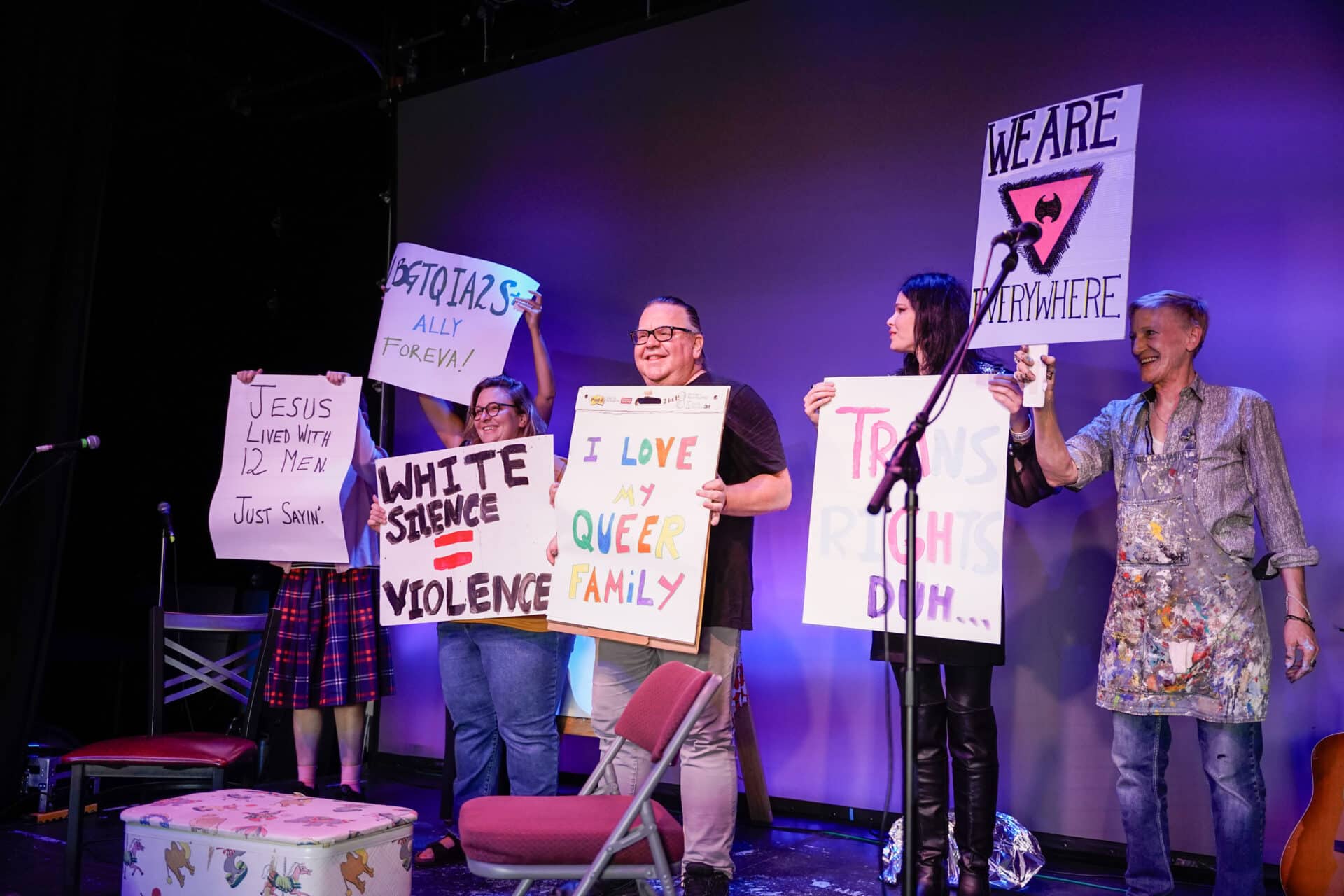 group of people holding posters.