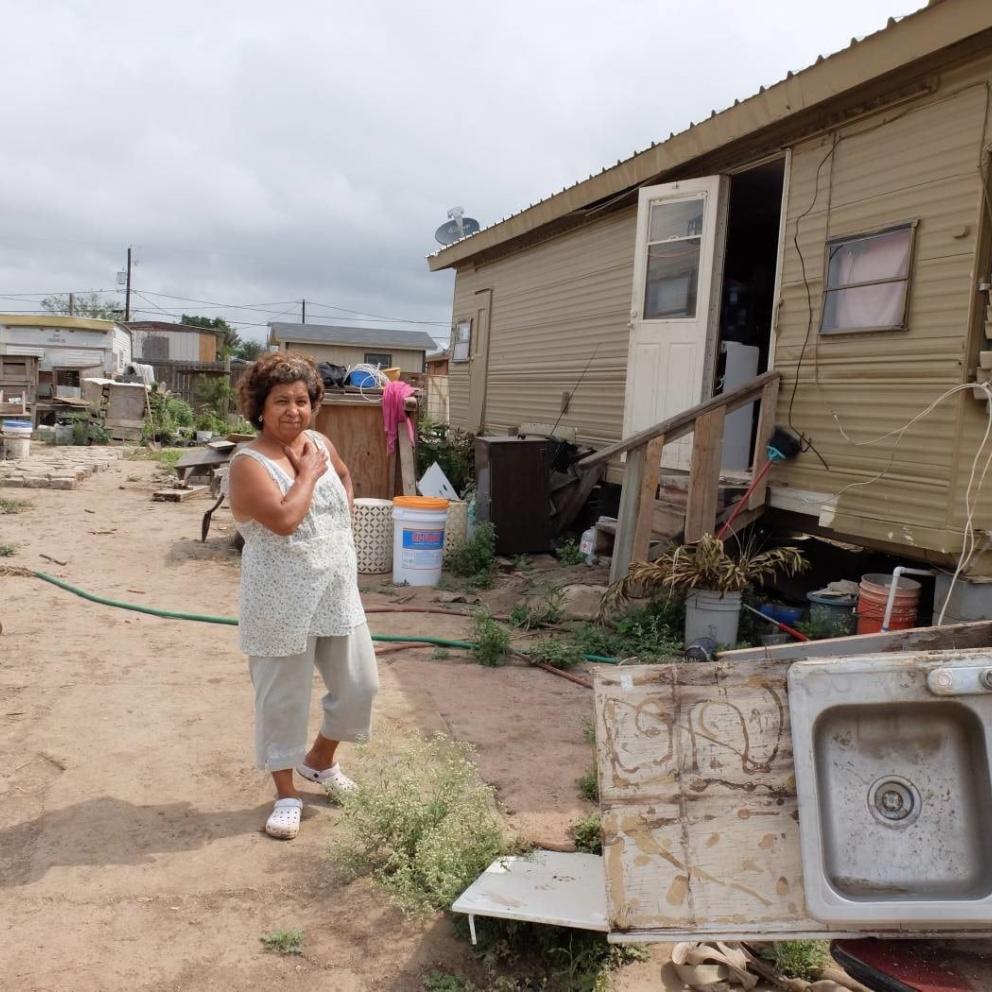 A woman standing in front of a trailer
